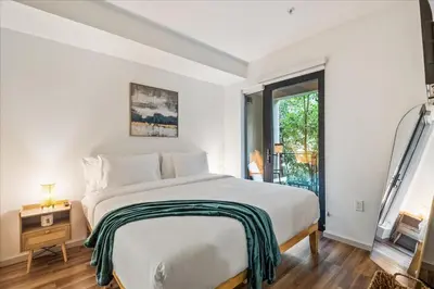 a white bedroom with a large bed and a window at Cozy 1BR apt in Hollywood w Pool, Gym and Parking in Los Angeles
