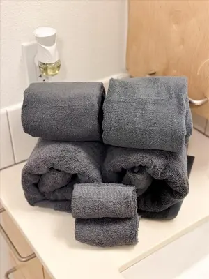 a pile of towels sitting on a counter in a bathroom at Cozy 1BR apt in Hollywood w Pool, Gym and Parking in Los Angeles