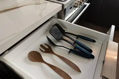 a drawer with wooden utensils on a counter at Modern 4 Bedroom Masterpiece With Rooftop Deck in Los Angeles