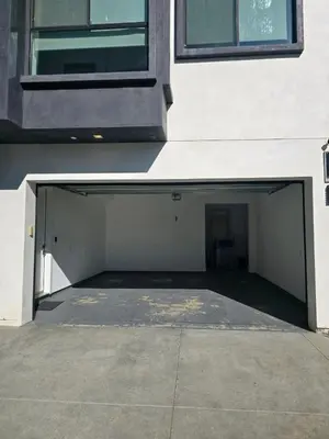 an empty parking garage next to a building at Modern 4 Bedroom Masterpiece With Rooftop Deck in Los Angeles