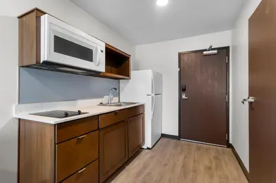 a kitchen with a sink and a microwave at WoodSpring Suites Palmdale - Lancaster in Palmdale