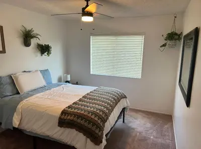 a bedroom with a bed and a window at Quaint Vintage Ranch Style 4BedRoom 2Bath Sleeps 10 in Lancaster