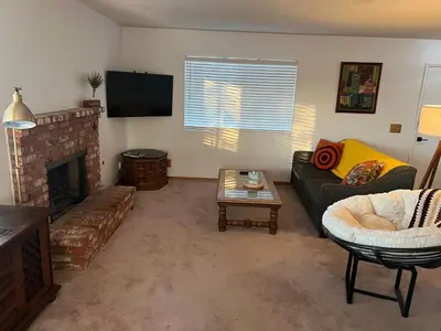 a living room with a couch and a fireplace at Quaint Vintage Ranch Style 4BedRoom 2Bath Sleeps 10 in Lancaster