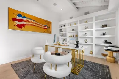 a white room with a desk and white chairs at Maravilla in Los Angeles