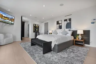 a bedroom with a large bed and a couch at Maravilla in Los Angeles
