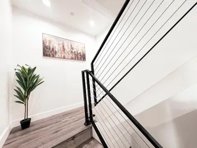 a staircase in a house with a potted plant at Cozy 3 BR Townhouse with Balcony in Los Angeles