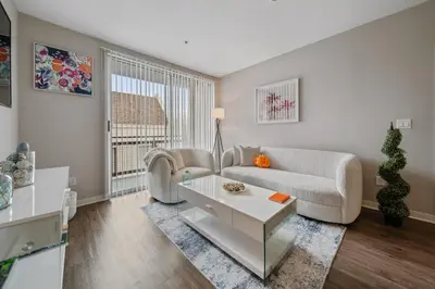 a living room with a couch and a table at Le Reve , 5 min to the beach Luxury Condo in Los Angeles