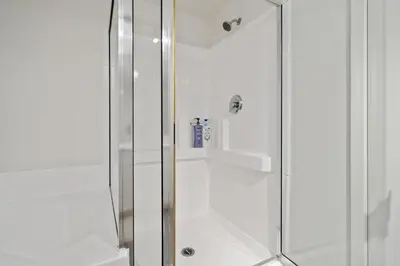 a shower with a glass door in a bathroom at Le Reve , 5 min to the beach Luxury Condo in Los Angeles