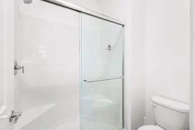 a bathroom with a glass shower with a toilet at Luxurious Ontario Townhouse Ideal Family in Ontario