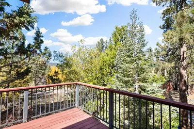 a balcony with a view of the woods at Silver Rays - Game room with pool table & air hockey! Close to the slopes!! in Big Bear Lake