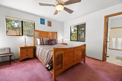a bedroom with a bed and a ceiling fan at Silver Rays - Game room with pool table & air hockey! Close to the slopes!! in Big Bear Lake