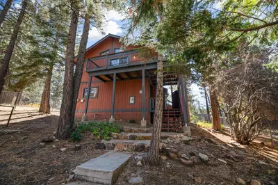 a house in the woods with a staircase leading up to it at Silver Rays - Game room with pool table & air hockey! Close to the slopes!! in Big Bear Lake