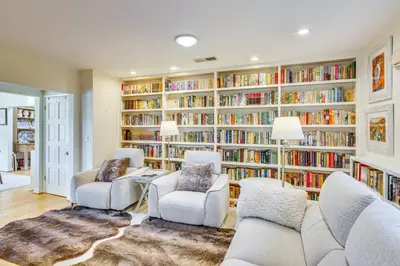 a living room with a large library of books at Vibrant Home with Patio - Near Santa Monica Pier! in Los Angeles