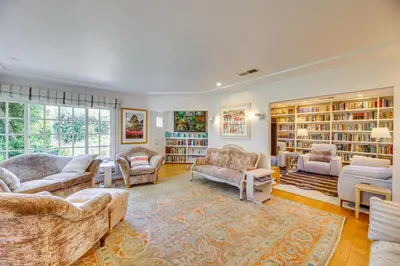 a living room with couches and bookshelves at Vibrant Home with Patio - Near Santa Monica Pier! in Los Angeles