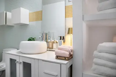 a bathroom with a sink and towels on a counter at Bright lights central Downtown in Los Angeles