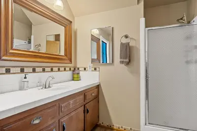 a bathroom with a sink and a shower at Pine Oaks Cabin in Lake Arrowhead