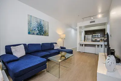 a living room with a blue couch and a table at The Carlton - Modern-Lux 2 Master Suites-Secure Bldg & Parking- 5 BLKS to Ocean Ave in Los Angeles