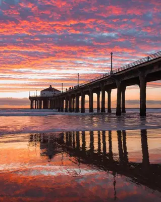 a pier on the beach with a sunset at The Carlton - Modern-Lux 2 Master Suites-Secure Bldg & Parking- 5 BLKS to Ocean Ave in Los Angeles