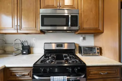 a kitchen with a stove and a microwave at 1 bd guest house in LA perfect for long term stay in Los Angeles