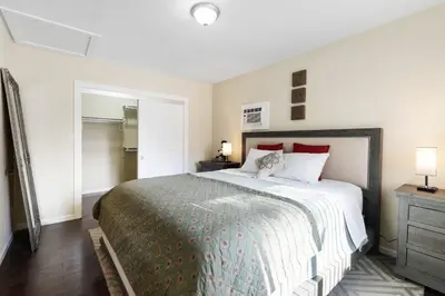 a bedroom with a large bed with red pillows at 1 bd guest house in LA perfect for long term stay in Los Angeles