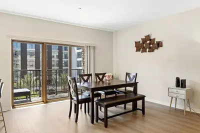 a dining room with a table and chairs and a window at Charming 2BR2BA Home Near Downtown LA And Walkable Amenities in Monterey Park