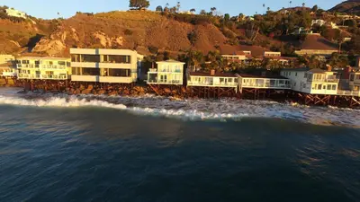 a group of houses on the beach near the water at Malibu Private Beach Apartments in Malibu