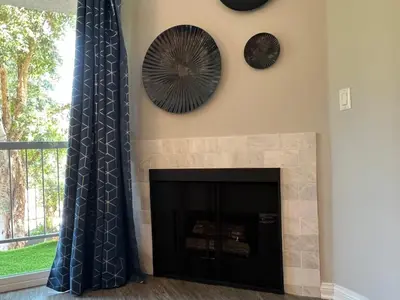 a fireplace with a mirror and a clock on the wall at Exceptional 2 BR in Heart of Hollywood 201 in Los Angeles