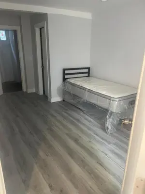 a bedroom with a bed in the corner of a room at UCLA Thurston in Los Angeles