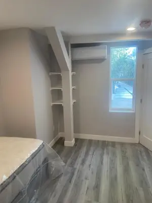 an empty room with a bed and a window at UCLA Thurston in Los Angeles