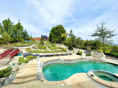 a swimming pool in a garden with a fountain at Japanese Garden Yorba Linda Hills Luxury Home in Yorba Linda