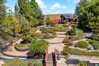 a garden with a building in the background at Japanese Garden Yorba Linda Hills Luxury Home in Yorba Linda