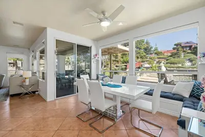 a dining room with a white table and a couch at Japanese Garden Yorba Linda Hills Luxury Home in Yorba Linda