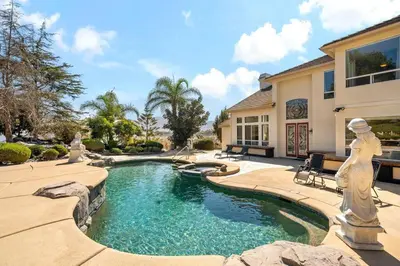 a swimming pool in a yard with a house at Japanese Garden Yorba Linda Hills Luxury Home in Yorba Linda