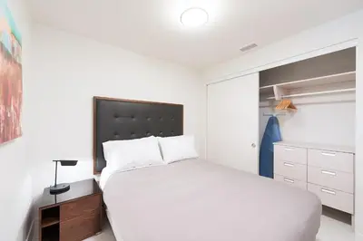 a bedroom with a white bed and a closet at 2 Bed 2 Bath Contemporary High Rise DTLA Living in Los Angeles