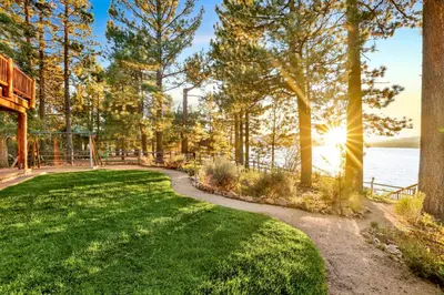 a path through a park next to a body of water at Eagle point lake house #2471 in Big Bear Lake