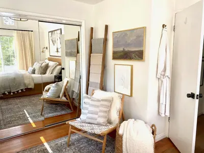a room with a mirror and a chair and a bed at Zen Treehouse Retreat-Great Views & Peaceful Decks in Los Angeles