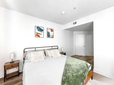 a white bedroom with a bed with a green blanket at Stylish 1bd in Marina Del Rey with Free Parking in Los Angeles