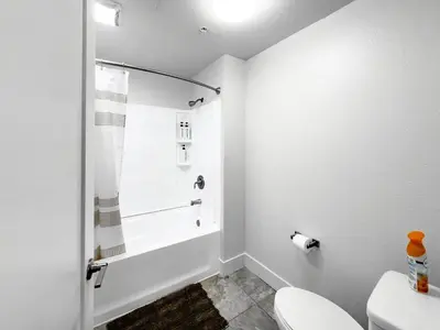 a white bathroom with a tub and a toilet at Stylish 1bd in Marina Del Rey with Free Parking in Los Angeles