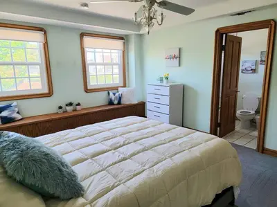 a bedroom with a large bed and a bathroom at Luxury Hill Villa with Spectacular View in Anaheim