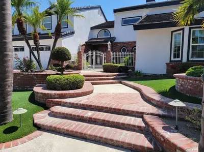 a house with stairs in front of a house at Luxury Hill Villa with Spectacular View in Anaheim