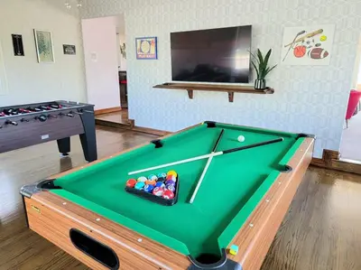 a pool table with a tray of balls on it at Luxury Hill Villa with Spectacular View in Anaheim
