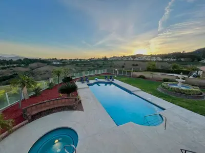 a view of a swimming pool with a fountain at Top of the World Anaheim View Home in Anaheim