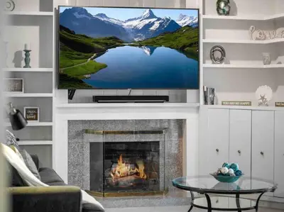 a living room with a fireplace with a tv above it at Secluded Romantic Getaway Home in Anaheim