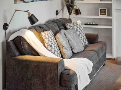 a couch with pillows on it in a living room at Secluded Romantic Getaway Home in Anaheim
