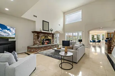 a living room with couches and a fireplace at Luxury Oasis With Panoramic Views in Anaheim