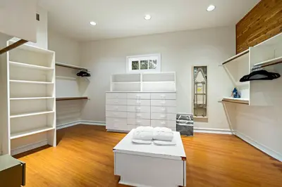 a large room with white shelves and a white bench at Luxury Oasis With Panoramic Views in Anaheim