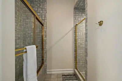 a bathroom with a shower with a glass door at Luxury Oasis With Panoramic Views in Anaheim