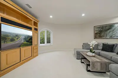 a living room with a couch and a large window at Luxury Oasis With Panoramic Views in Anaheim