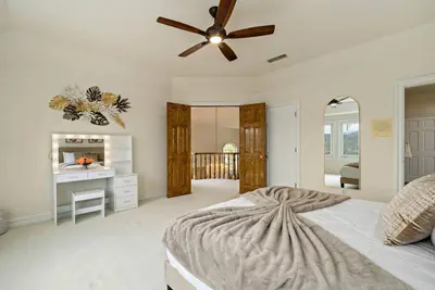a bedroom with a bed and a ceiling fan at Luxury Oasis With Panoramic Views in Anaheim