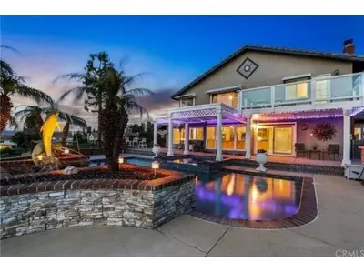 a house with a swimming pool in front of it at Majestic Anaheim Panorama Hill Home With Sunset in Anaheim